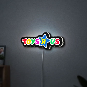 Toys R Us LED lightbox hanging on a wall with white glow