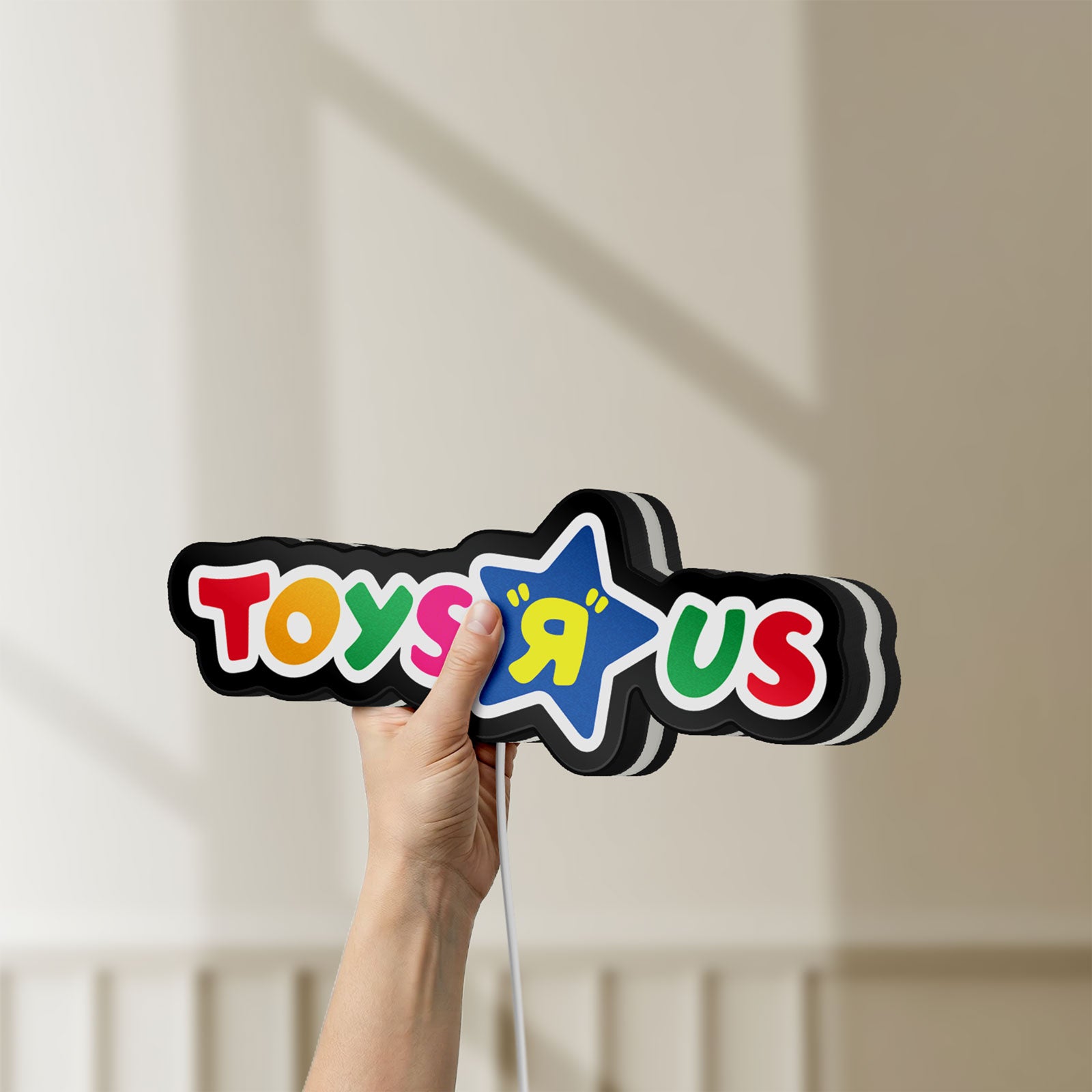 Unlit Toys R Us LED lightbox held by hand to show size and details