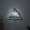 Gujarat Titans LED lightbox hanging on a wall with yellow glow