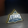 Gujarat Titans LED lightbox standing on a desk from an angled side view with yellow glow
