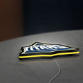 Gujarat Titans LED lightbox lying flat on a desk with yellow glow