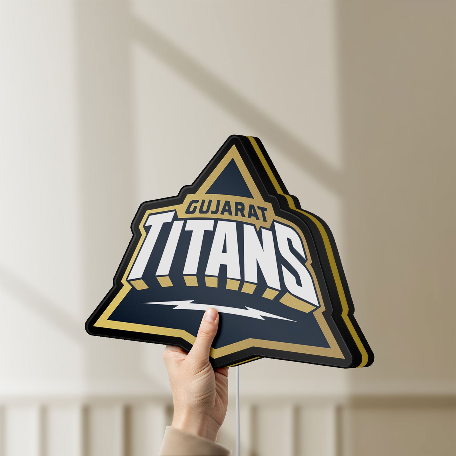 Unlit Gujarat Titans LED lightbox held by hand to show size and details