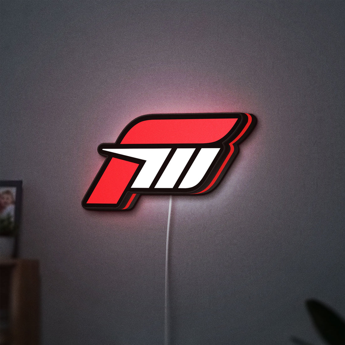Forza Motorsport 3 LED lightbox hanging on a wall with red glow