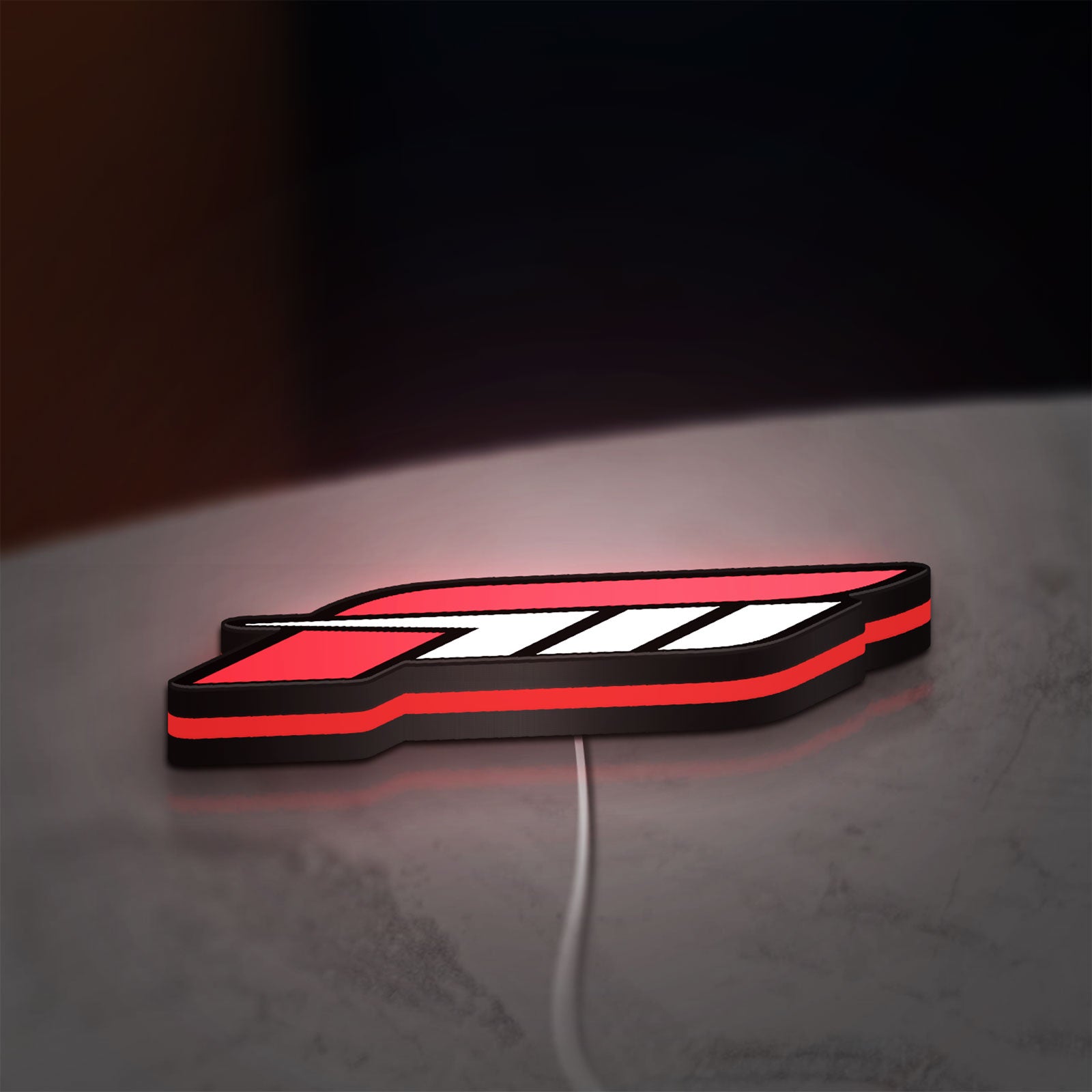Forza Motorsport 3 LED lightbox lying flat on a desk with red glow