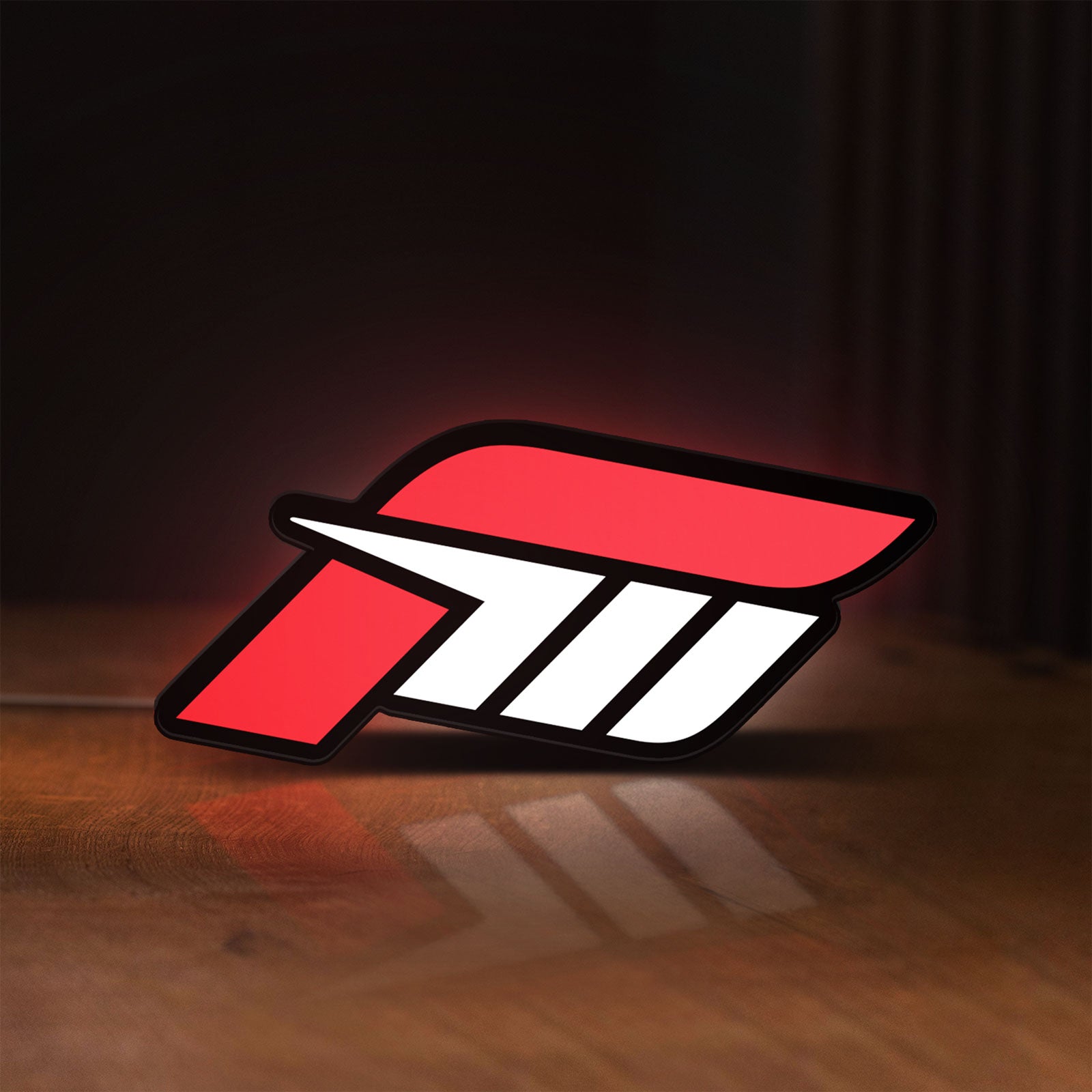 Front view of Forza Motorsport 3 LED lightbox sign glowing on a wooden desk