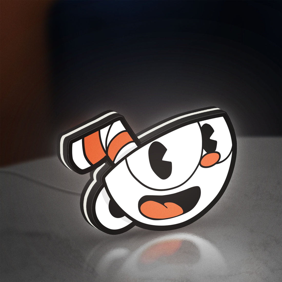 Cuphead LED lightbox hanging on a wall with white glow