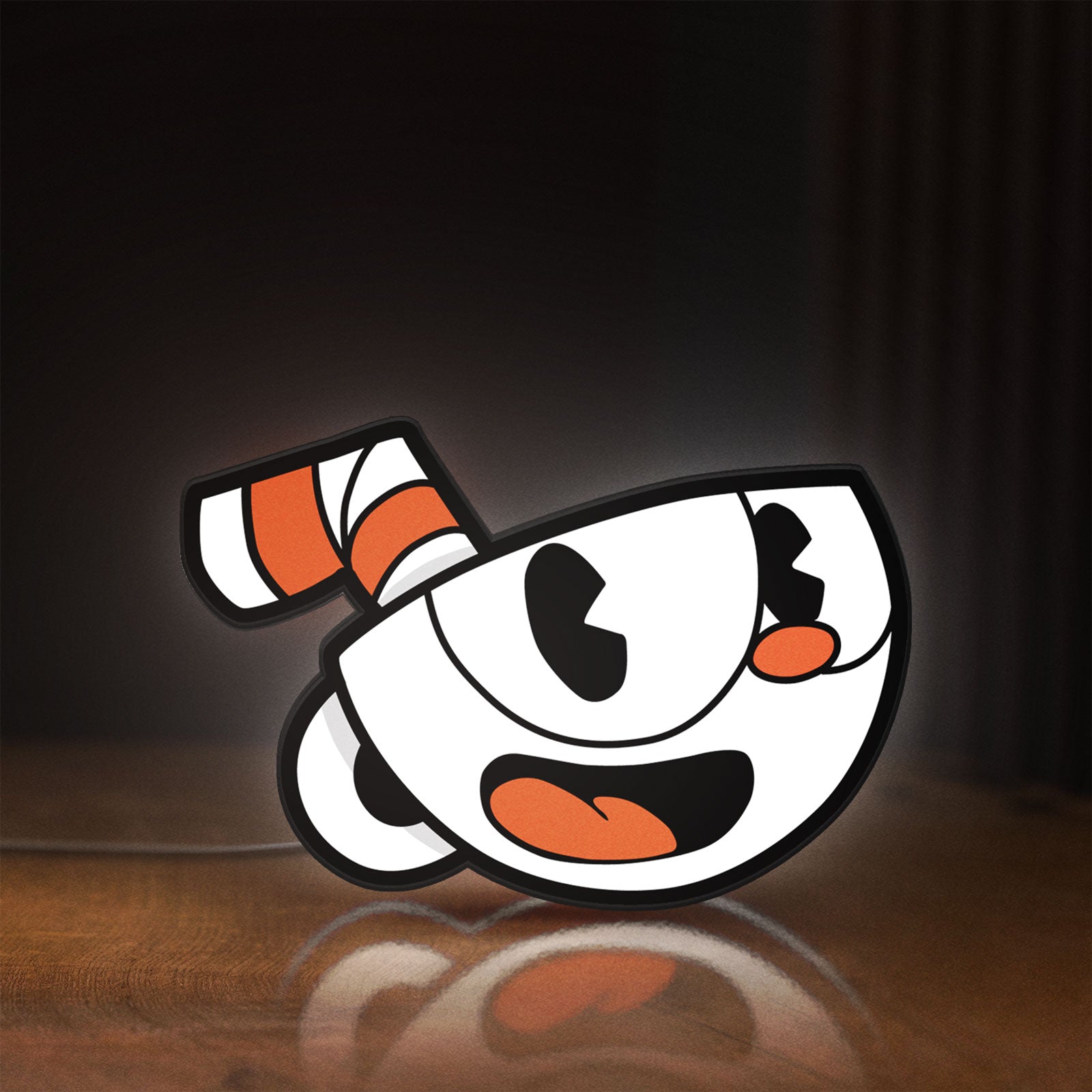Front view of Cuphead LED lightbox sign glowing on a wooden desk