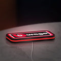 Bburago LED lightbox lying flat on a desk with red glow