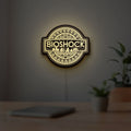 BioShock Rapture City LED lightbox hanging on a room wall with soft yellow light
