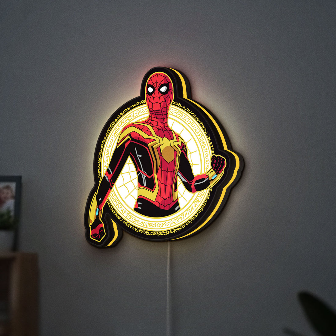 Spiderman LED lightbox hanging on a wall with yellow glow