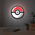 Pokémon Pokéball Legue LED lightbox hanging on a room wall with soft white light