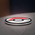 Pokémon Pokéball Legue LED lightbox lying flat on a desk with white glow