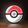 Front view of Pokémon Pokéball Legue LED lightbox sign glowing on a wooden desk