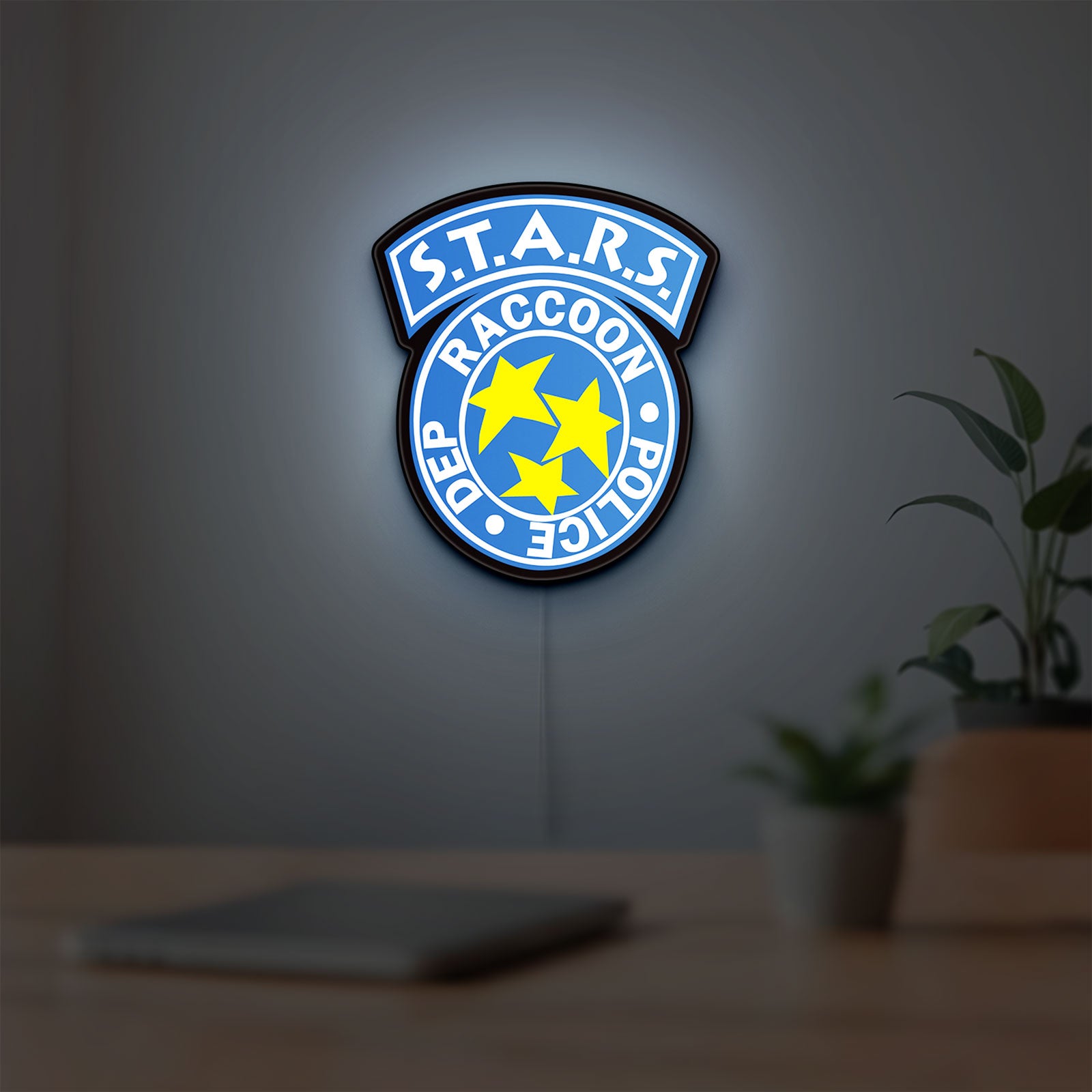 Raccoon City STARS LED lightbox hanging on a room wall with soft blue light