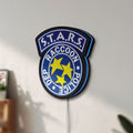 Unlit Raccoon City STARS LED lightbox mounted on a wall in daylight