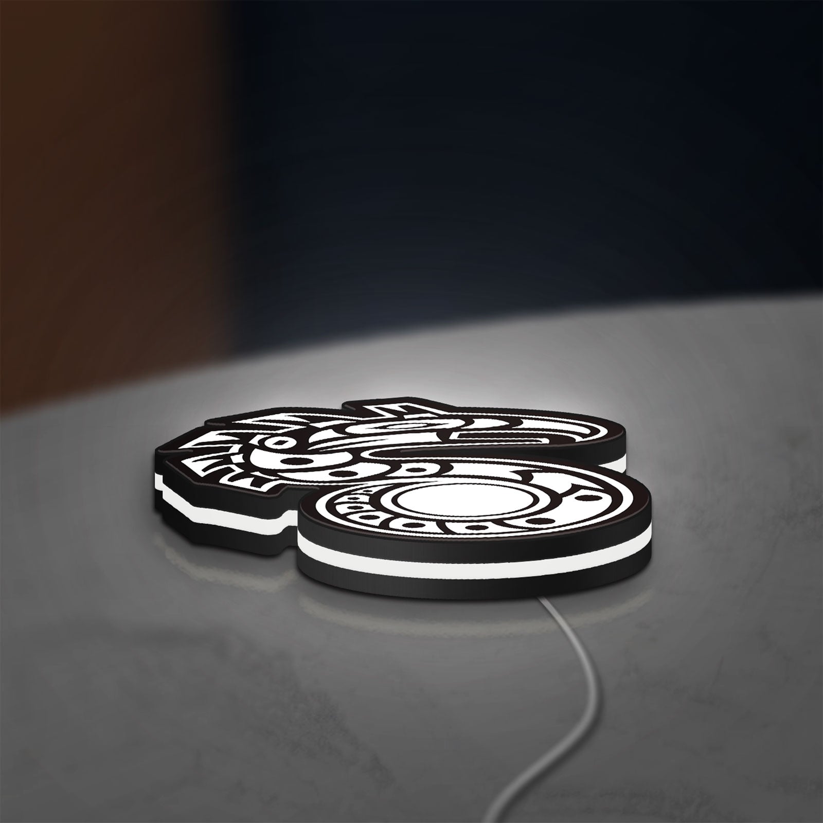Shadowrun LED lightbox lying flat on a desk with white glow