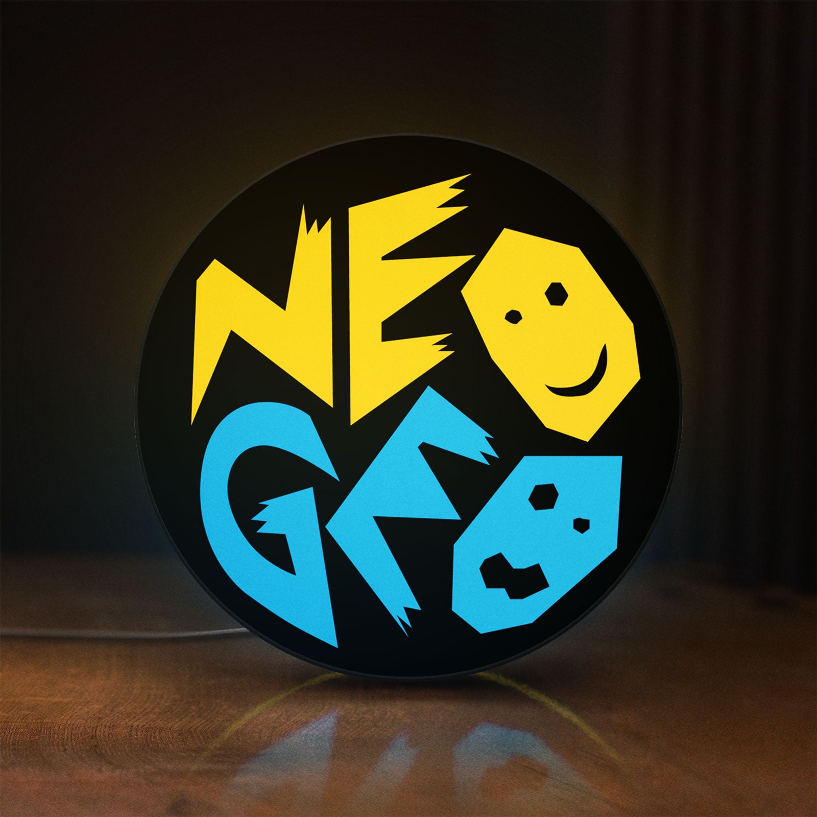 Front view of SNK NeoGeo LED lightbox sign glowing on a wooden desk