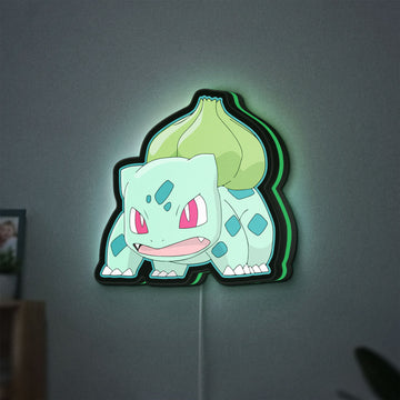 Bulbasaur LED lightbox hanging on a wall with green glow