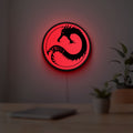Battletech House Kurita LED lightbox hanging on a room wall with soft red light
