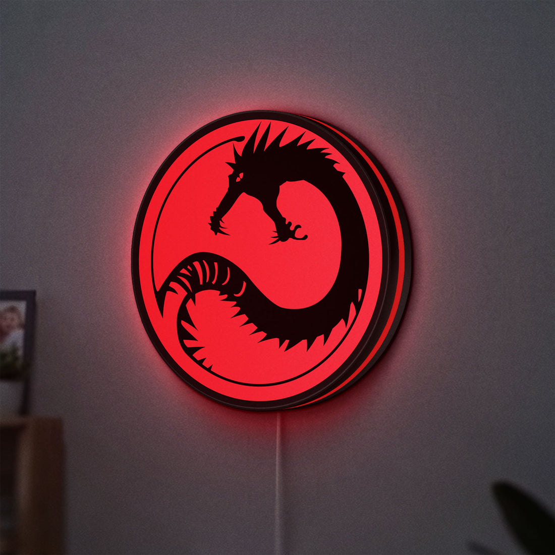Battletech House Kurita LED lightbox hanging on a wall with red glow