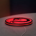 Battletech House Kurita LED lightbox lying flat on a desk with red glow