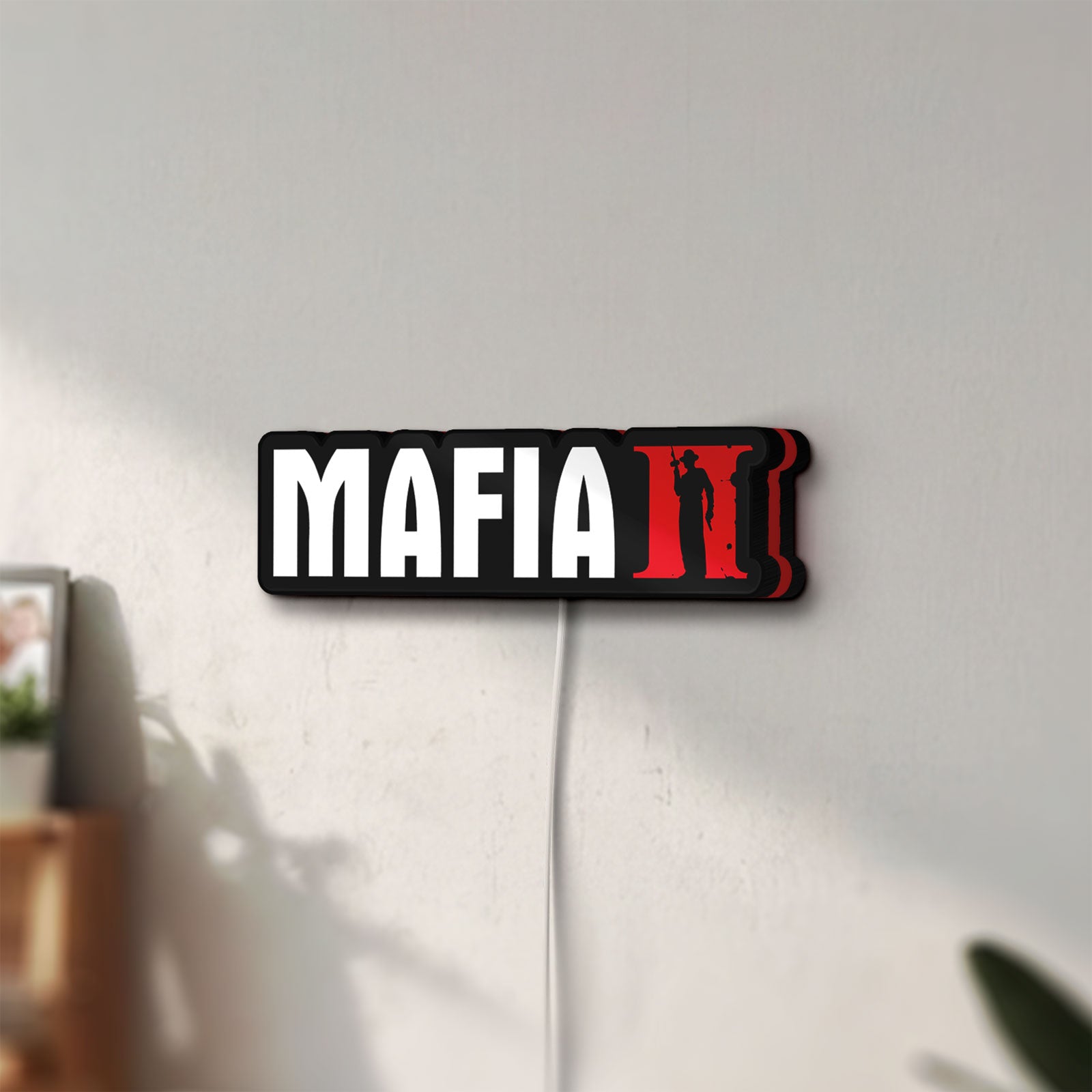 Unlit Mafia II LED lightbox mounted on a wall in daylight