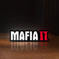 Front view of Mafia II LED lightbox sign glowing on a wooden desk
