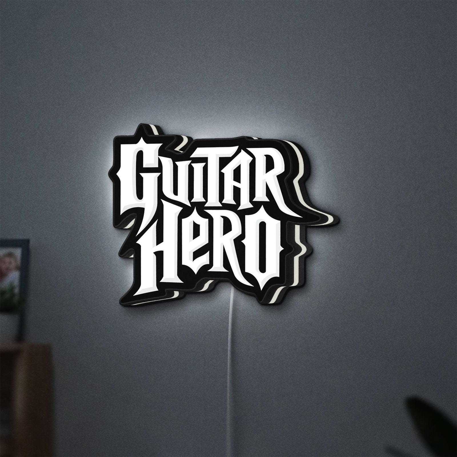 Guitar Hero LED lightbox hanging on a wall with white glow