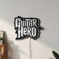 Unlit Guitar Hero LED lightbox mounted on a wall in daylight