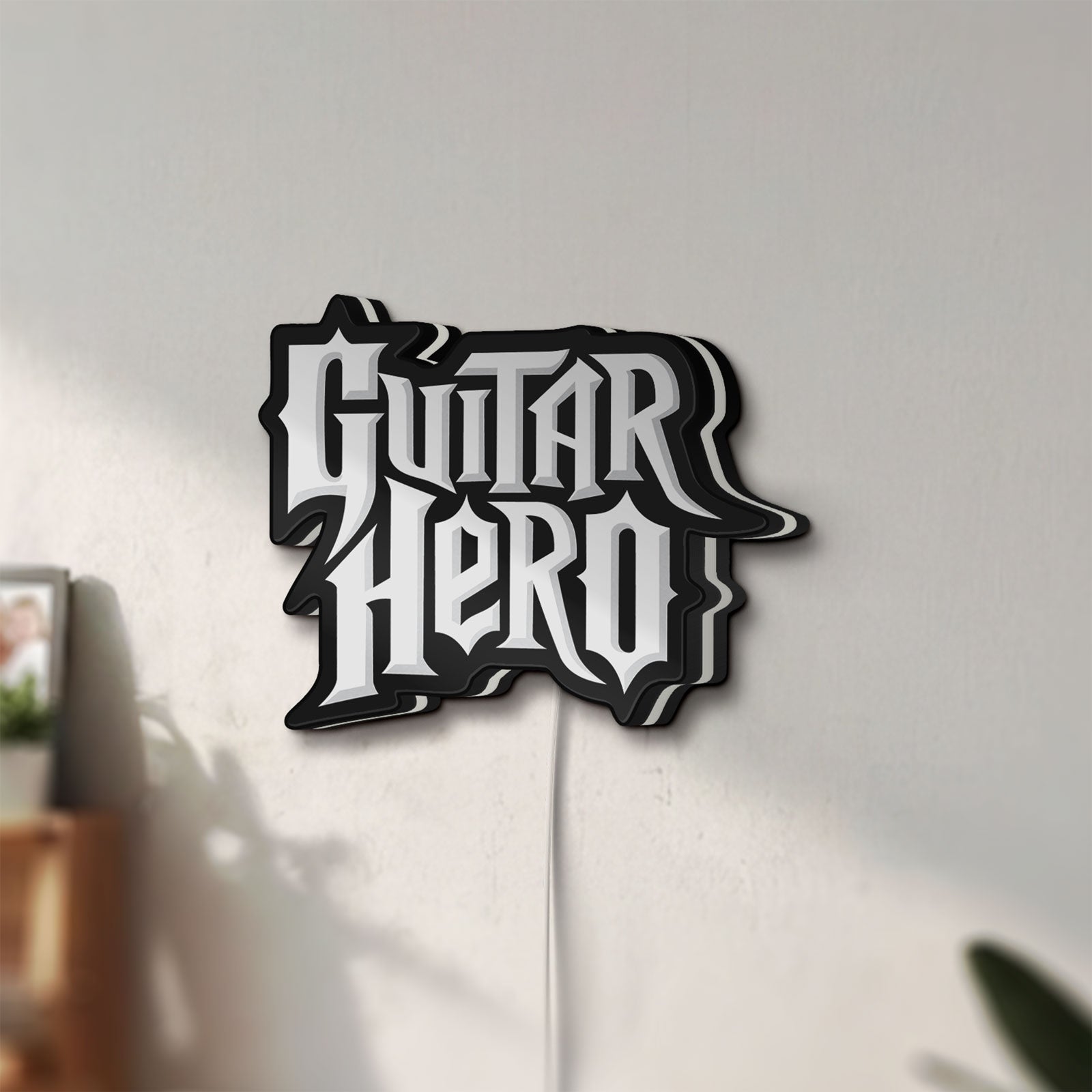 Unlit Guitar Hero LED lightbox mounted on a wall in daylight