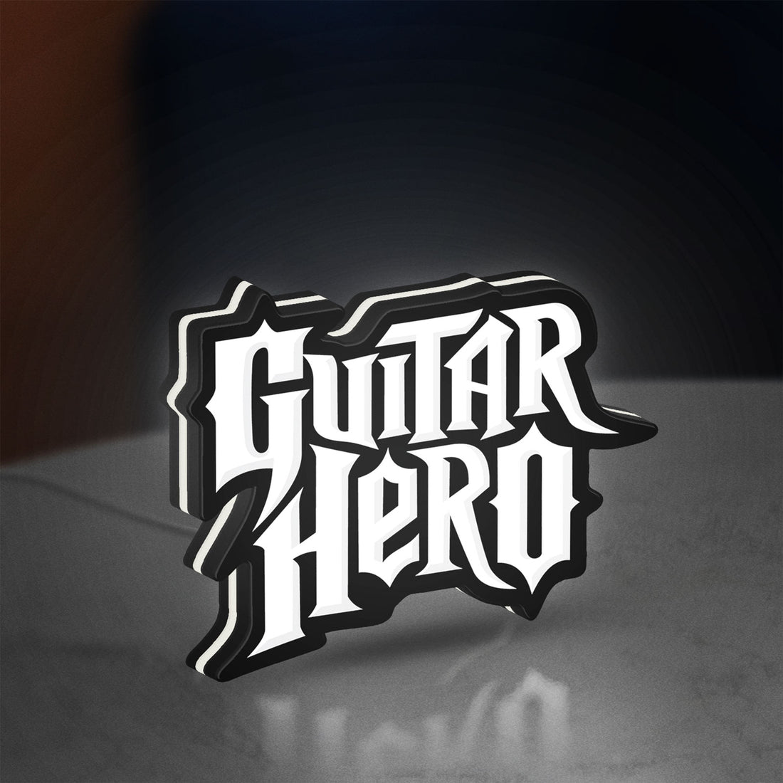 Guitar Hero LED lightbox hanging on a wall with white glow