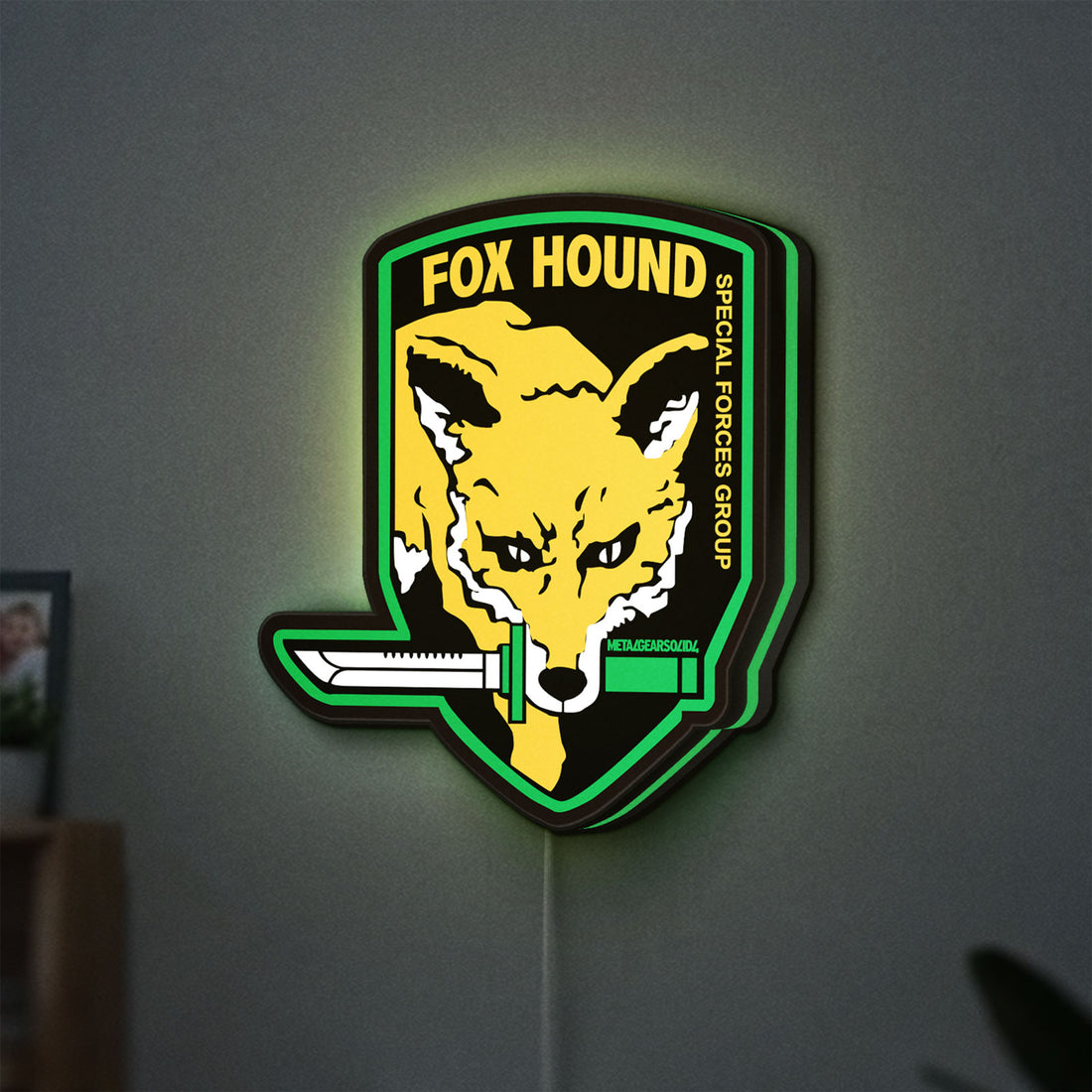 Fox Hound Special Forces LED lightbox hanging on a wall with green glow