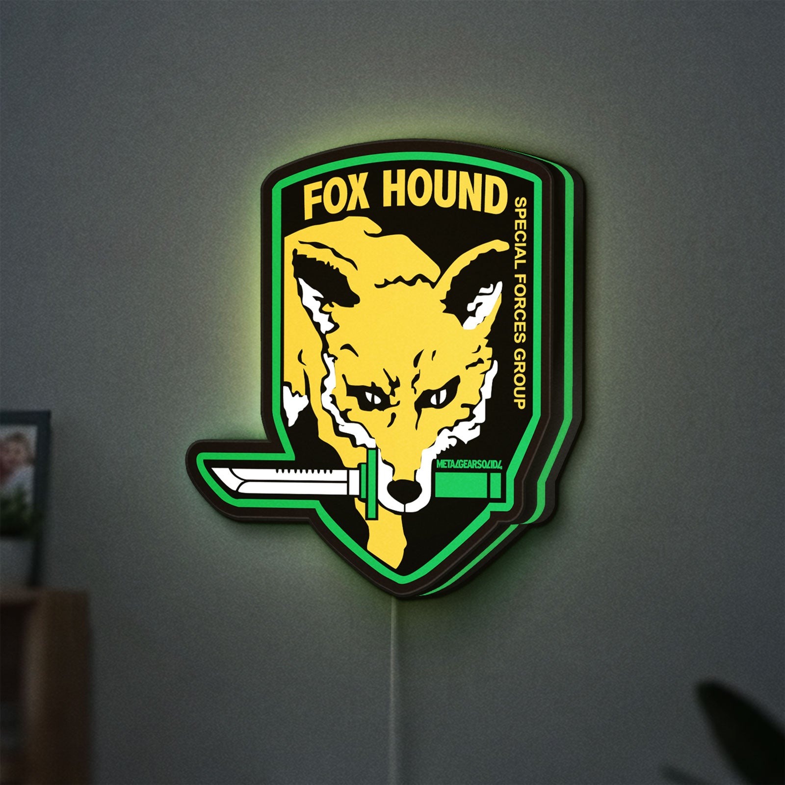 Fox Hound Special Forces LED lightbox hanging on a wall with green glow