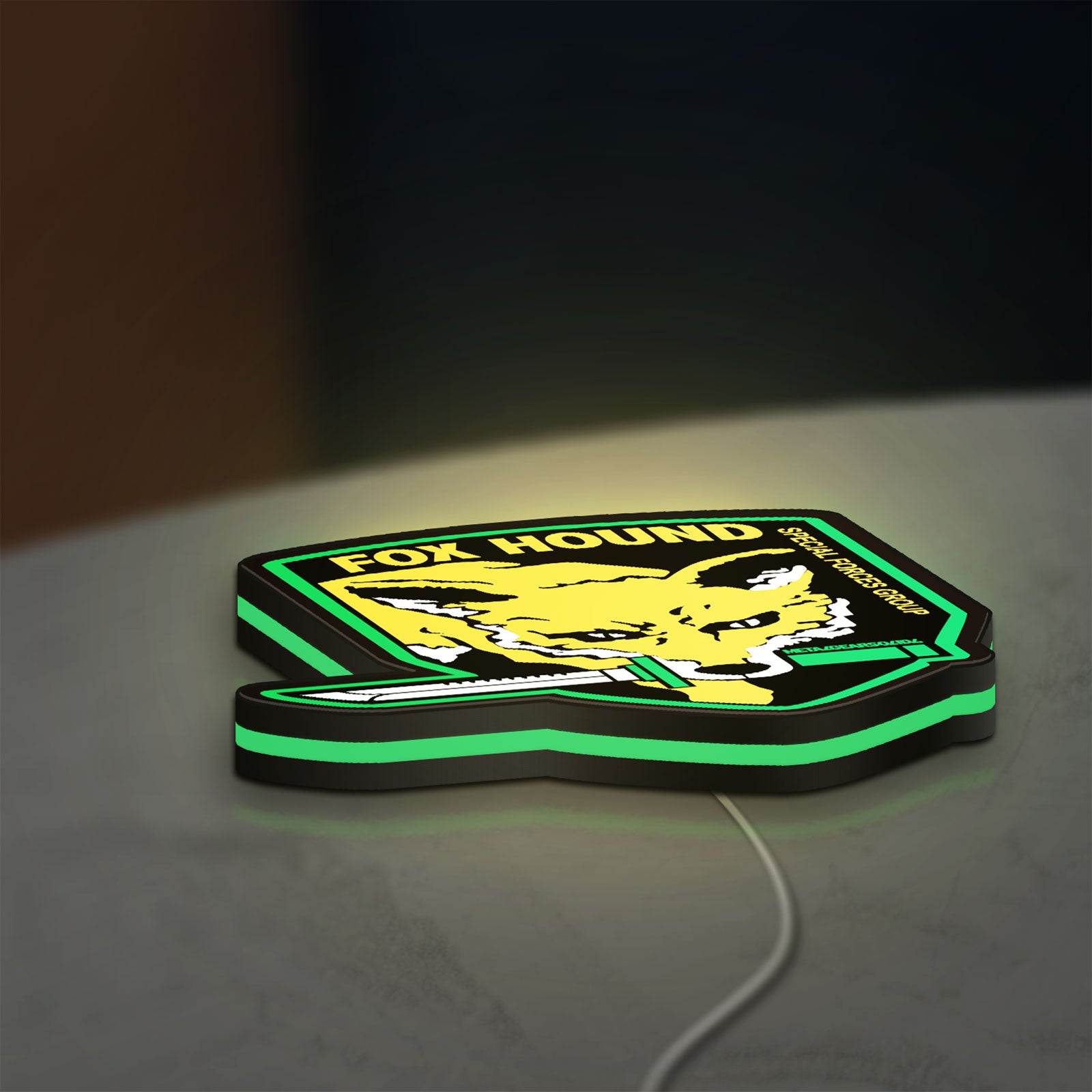 Fox Hound Special Forces LED lightbox lying flat on a desk with green glow