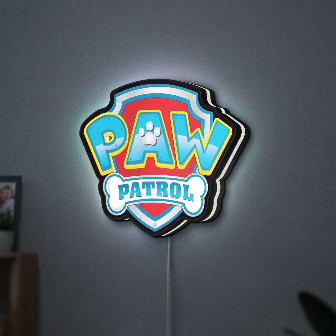 Paw Patrol LED lightbox hanging on a wall with white glow