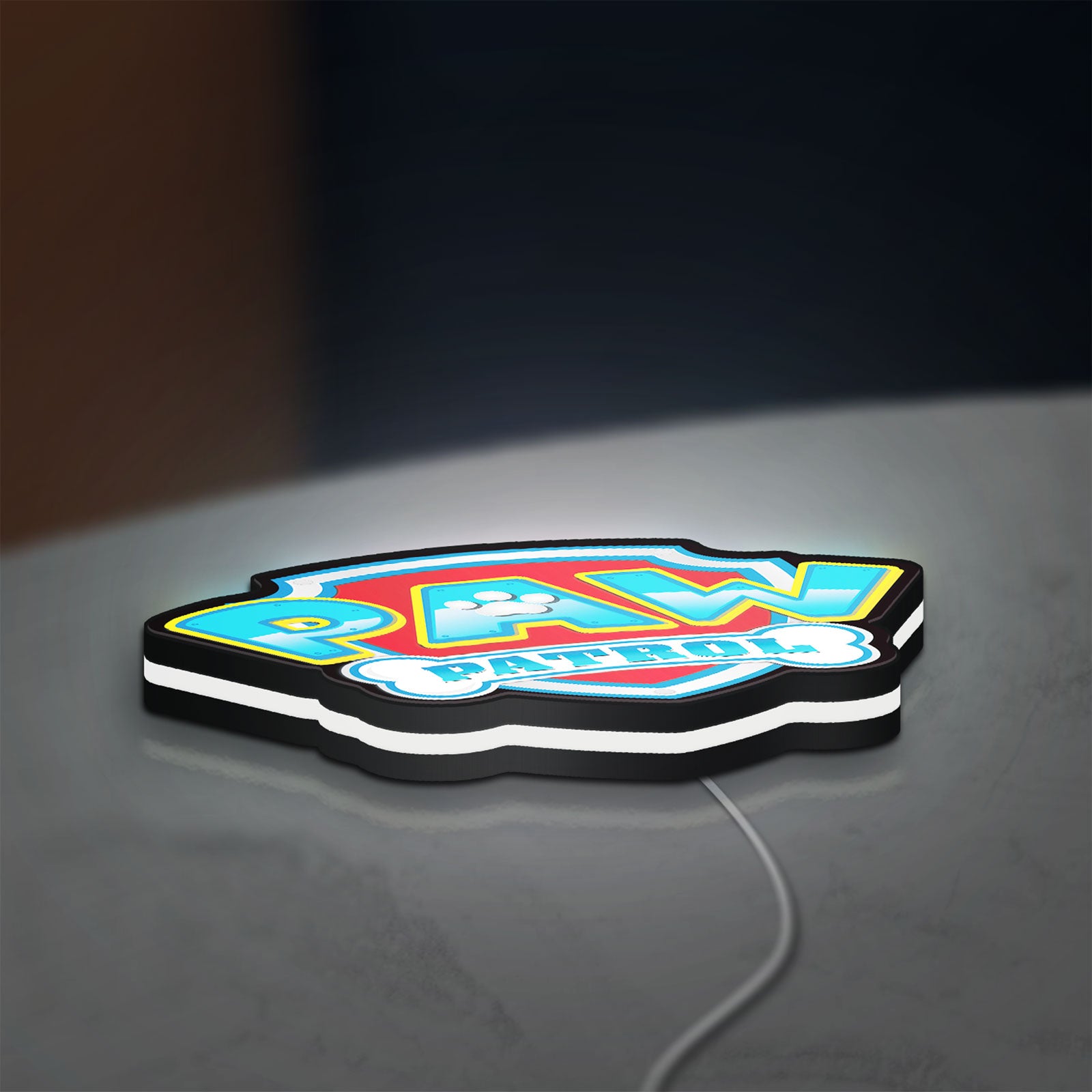 Paw Patrol LED lightbox lying flat on a desk with white glow