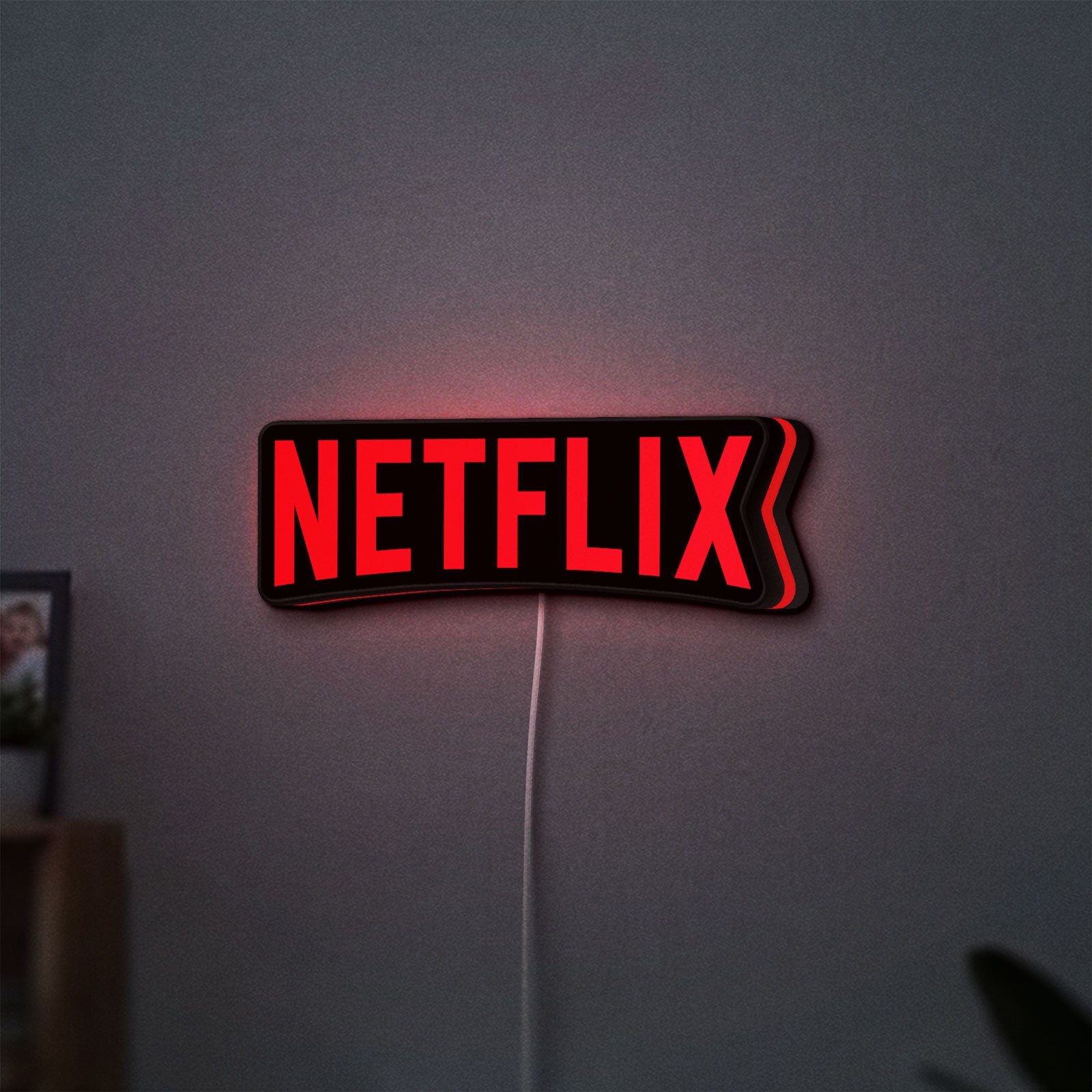 Netflix Style LED lightbox hanging on a wall with red glow