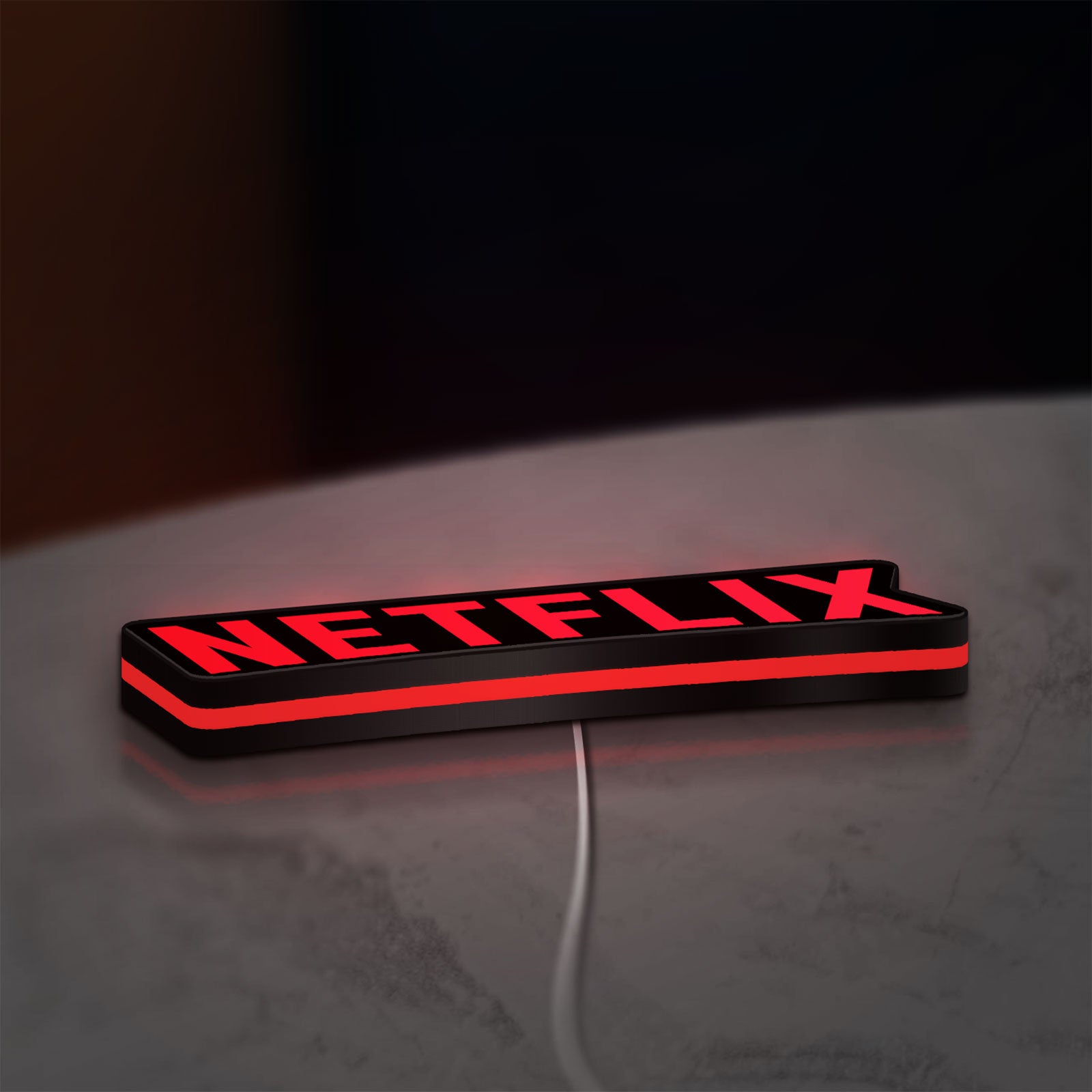 Netflix Style LED lightbox lying flat on a desk with red glow