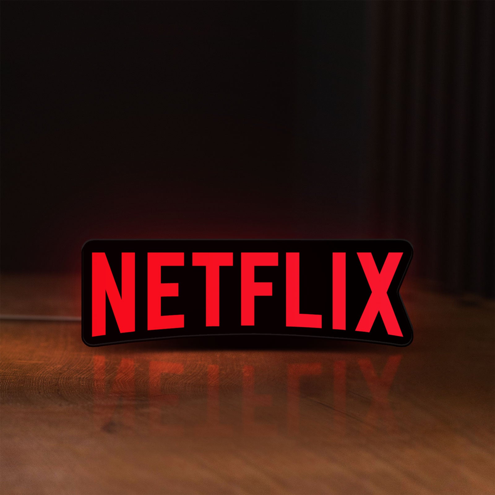 Front view of Netflix Style LED lightbox sign glowing on a wooden desk