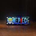 Front view of One Piece LED lightbox sign glowing on a wooden desk