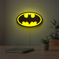 Batman LED lightbox hanging on a room wall with soft yellow light