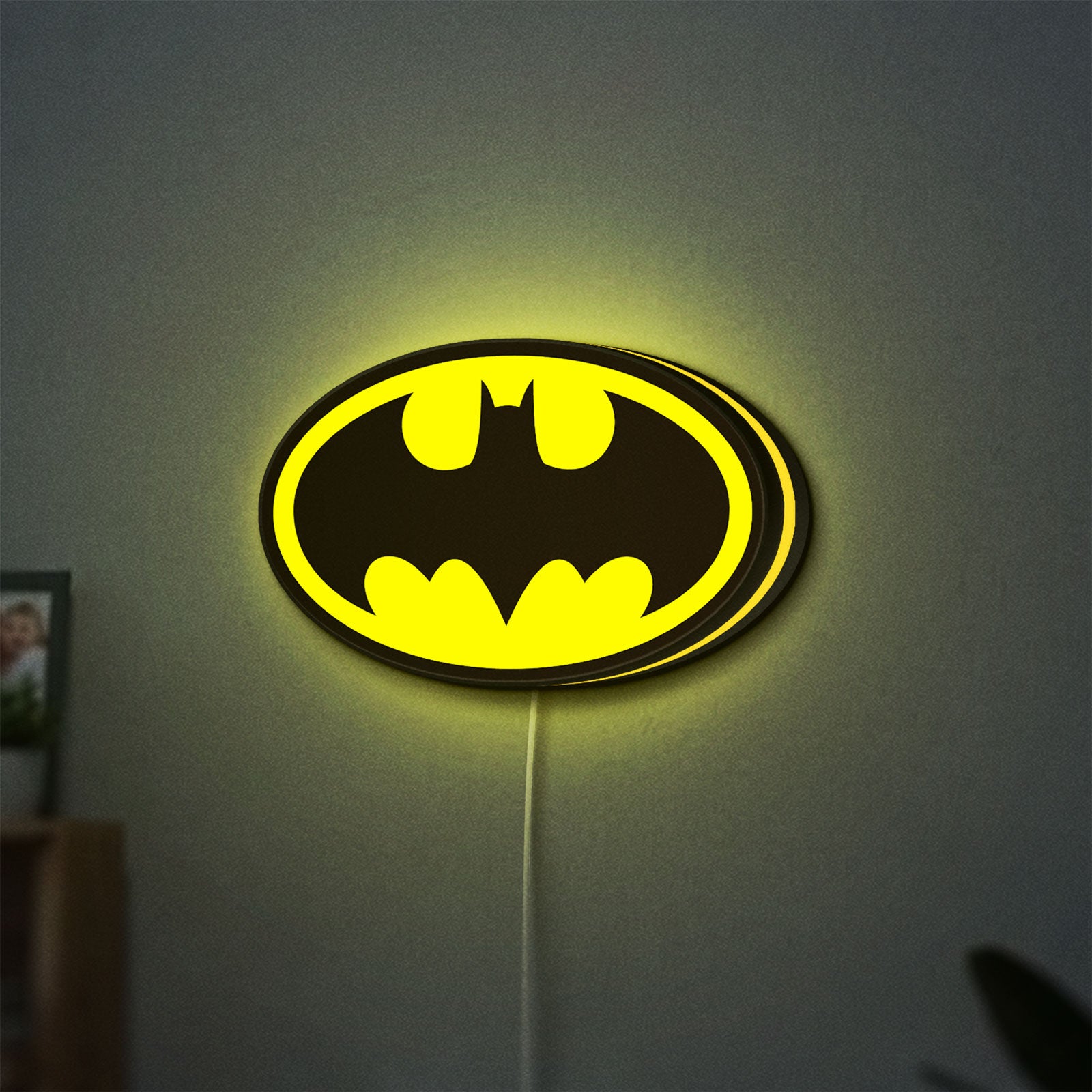 Batman LED lightbox hanging on a wall with yellow glow