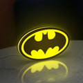 Batman LED lightbox standing on a desk from an angled side view with yellow glow