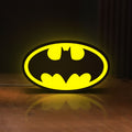 Front view of Batman LED lightbox sign glowing on a wooden desk