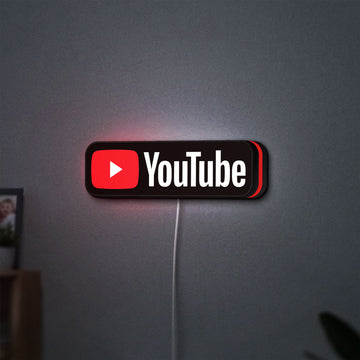 YouTube LED lightbox hanging on a wall with red glow