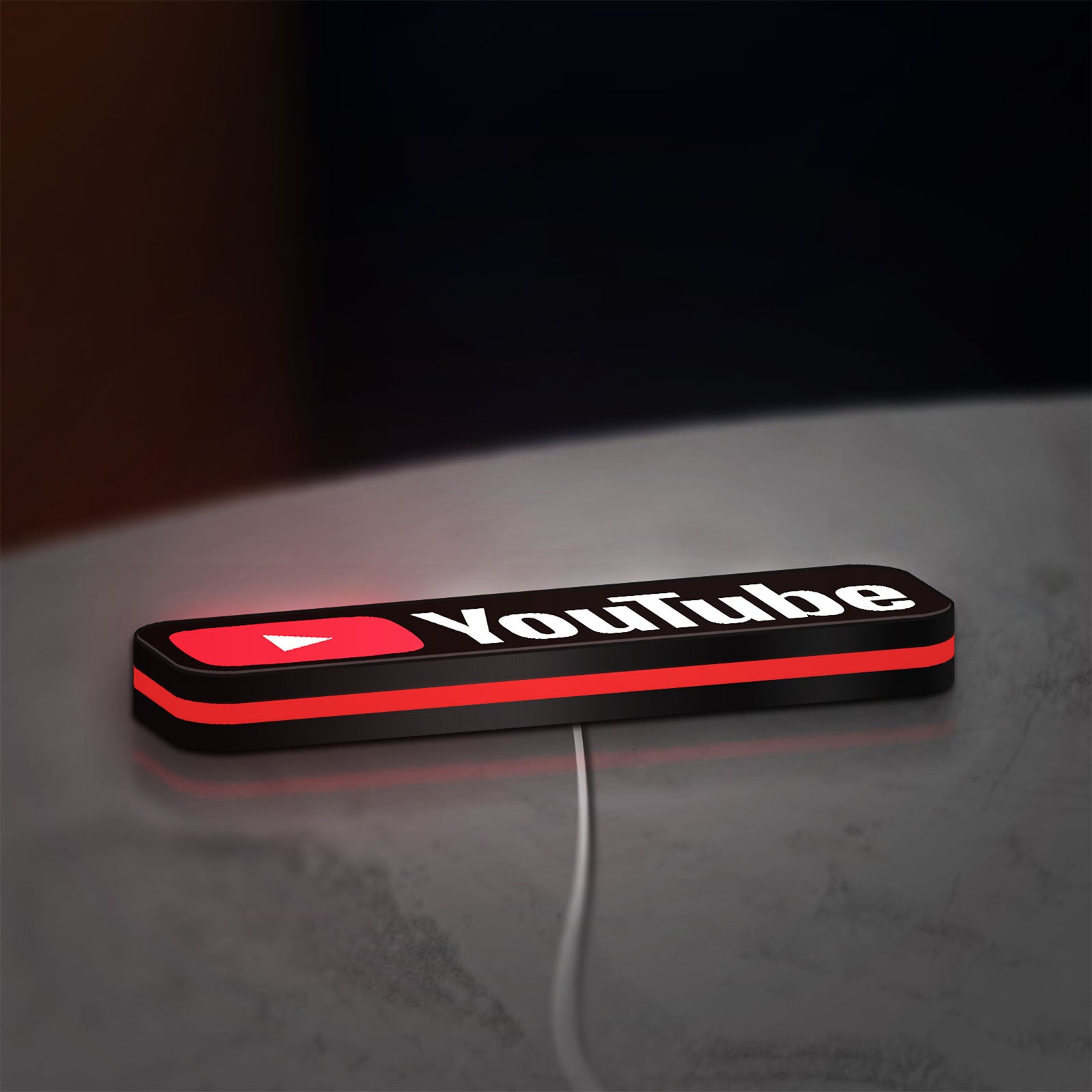 YouTube LED lightbox lying flat on a desk with red glow