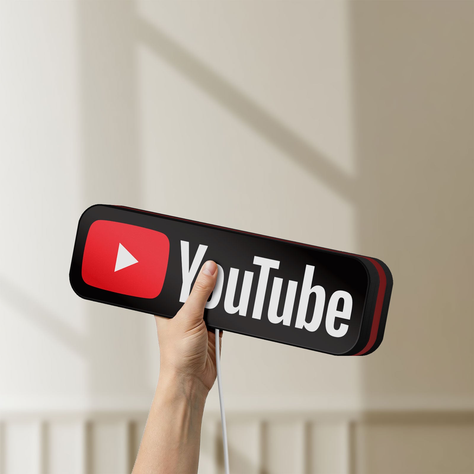 Unlit YouTube LED lightbox held by hand to show size and details