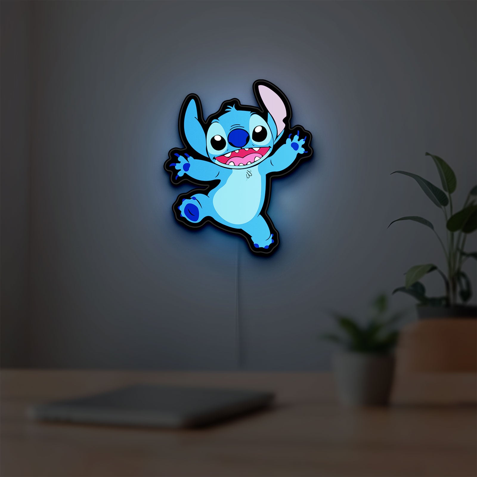 Stitch Happy LED lightbox hanging on a room wall with soft blue light