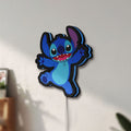 Unlit Stitch Happy LED lightbox mounted on a wall in daylight