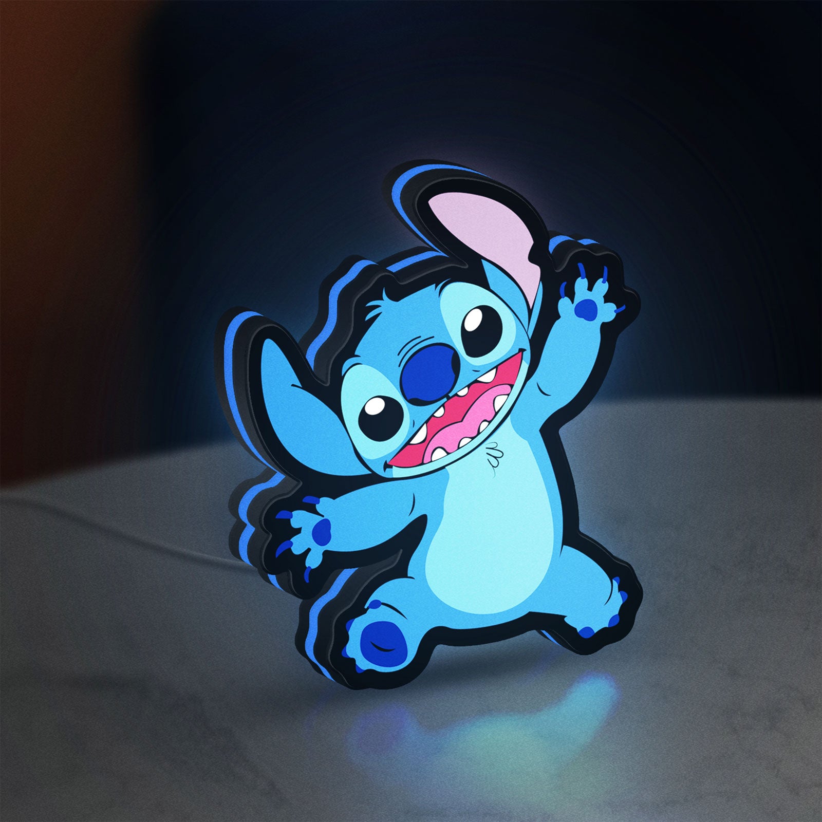 Stitch Happy LED lightbox standing on a desk from an angled side view with blue glow